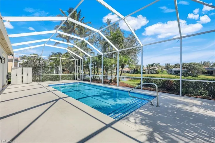 Screened enclosure featuring a heated saltwater swimming pool.