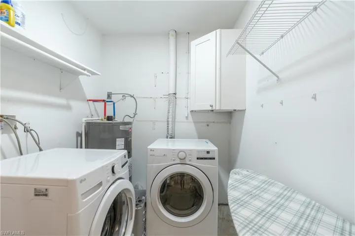 Washroom featuring washing machine and dryer and cabinet space
