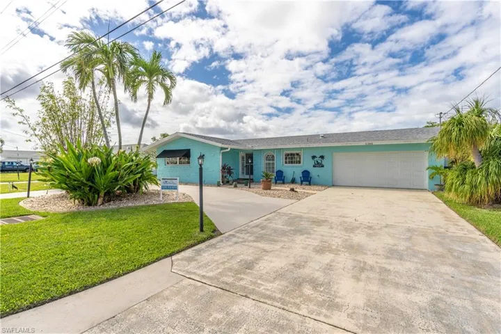 Single story home with concrete driveway, a front yard, and a garage