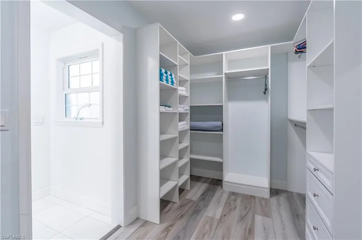 Walk in closet featuring light wood-style flooring