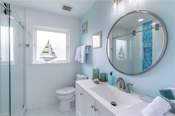 Full bathroom featuring vanity, a shower stall, and light tile patterned floors