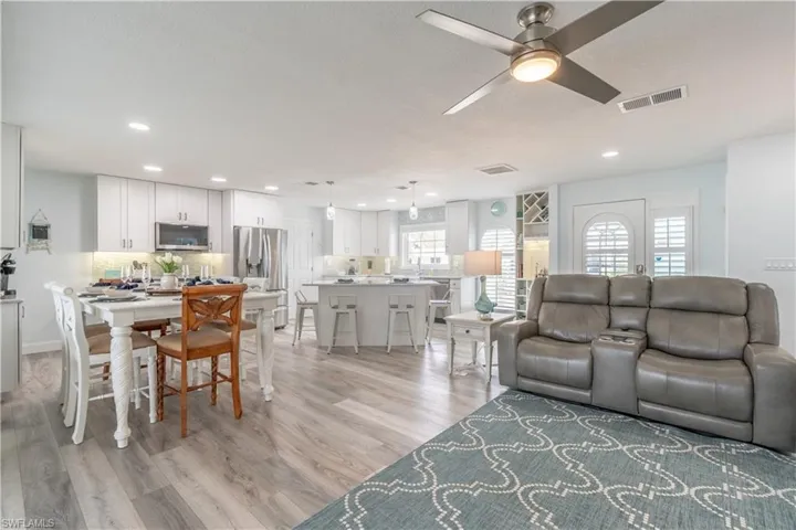 Living room with light wood-style floors, recessed lighting, and a ceiling fan