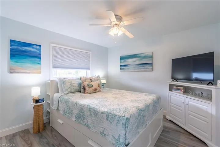 Bedroom with a ceiling fan and wood finished floors