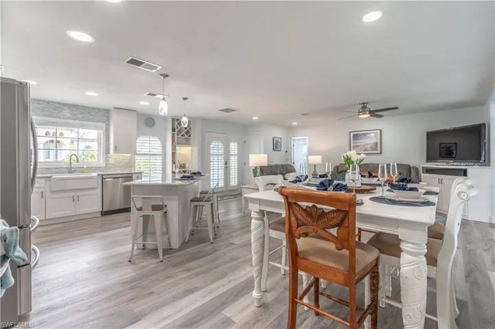 Dining area with light wood finished floors, recessed lighting, and a ceiling fan
