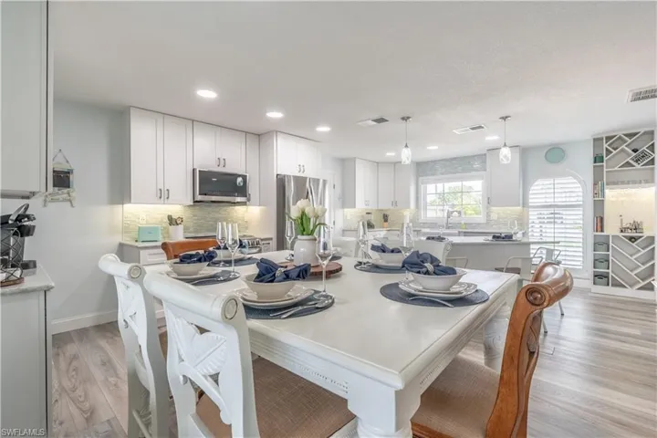 Dining room featuring light wood-style floors and recessed lighting