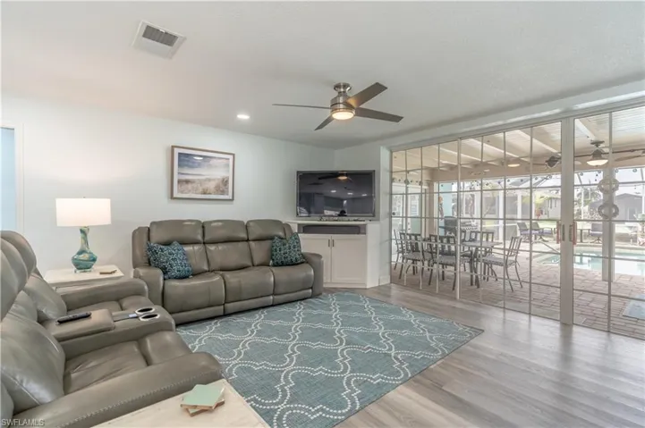 Living area featuring wood finished floors and ceiling fan