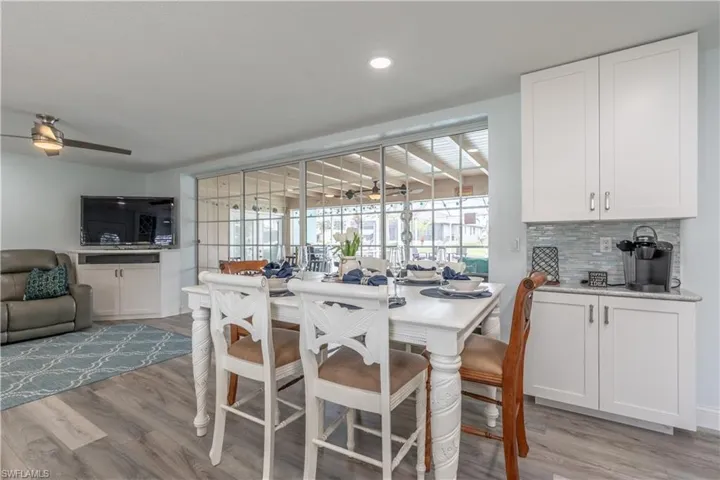 Dining area with light wood finished floors and recessed lighting