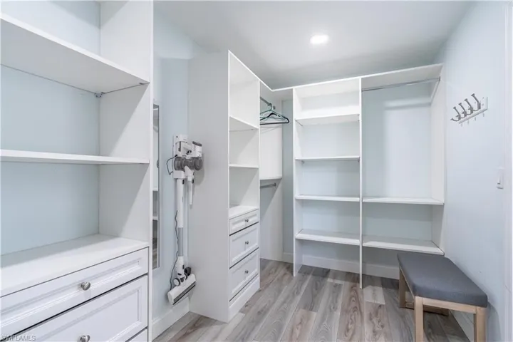 Walk in closet featuring light wood-style floors