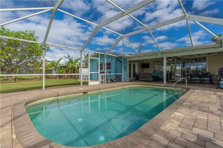 Swimming pool featuring a lanai, a sunroom, and a patio