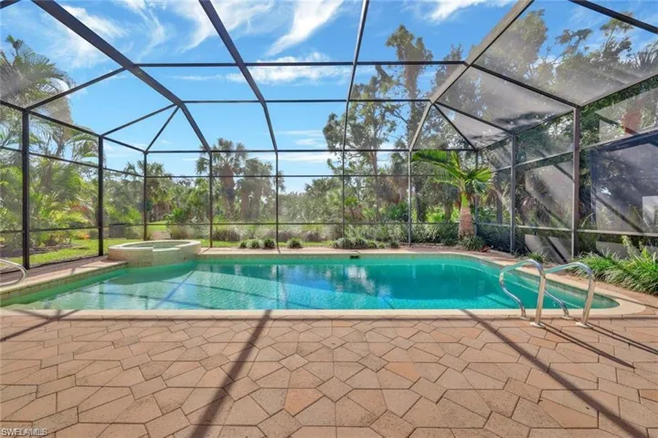 Integrated pool / spa featuring a sunroom, a patio area, and glass enclosure