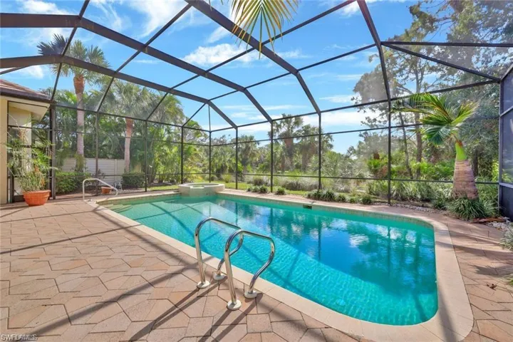 Integrated pool / hot tub featuring a sunroom, a lanai, and a patio
