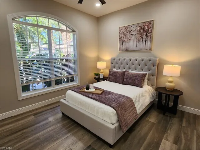 Bedroom with dark wood-style floors, recessed lighting, and ceiling fan