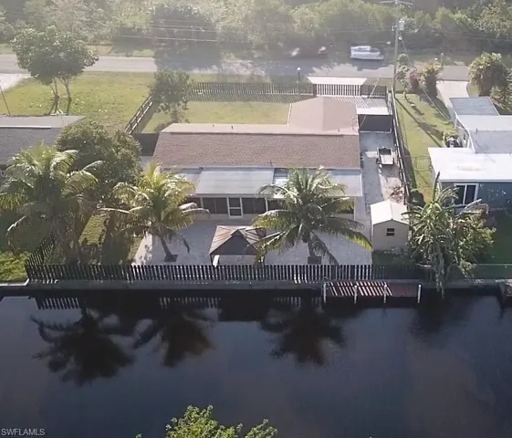 Birds eye view of property with a water view