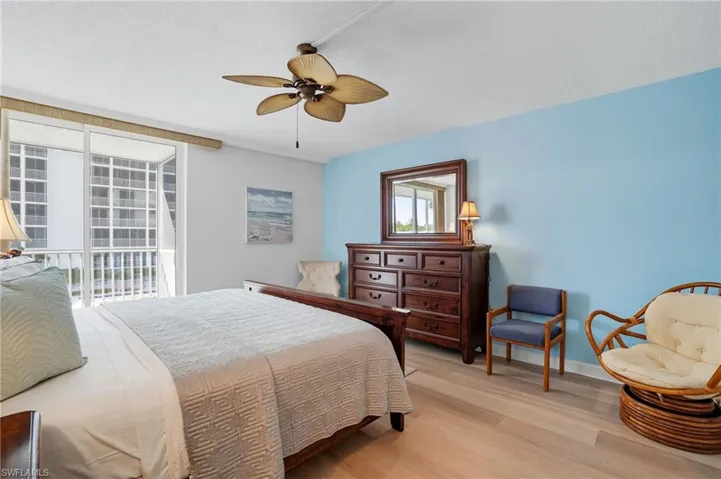 Light wood-finish flooring and a ceiling fan with integrated lighting