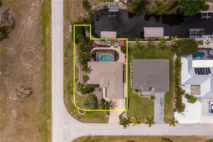 Aerial View of Home with Pool & Canal