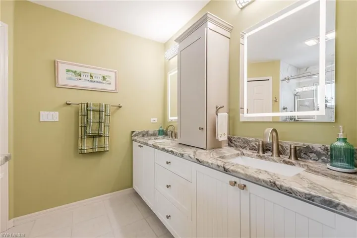 Updated Bathroom with Dual Sinks, Granite Countertops & LED Lighted Mirrors in Primary Bathroom