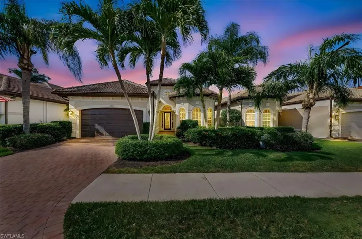 Mediterranean style home featuring a 2-car garage, decorative paver driveway, stucco siding