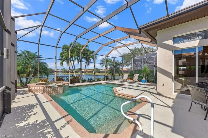 Integrated pool / hot tub featuring a patio area, a lanai and a large lake view