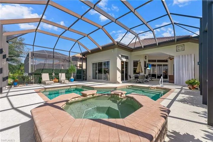 Relaxing pool / spa featuring and beautiful patio area with outdoor dining area