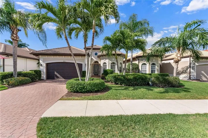 Mediterranea style home featuring a 2-car garage, decorative paver driveway, stucco siding, a tile roof