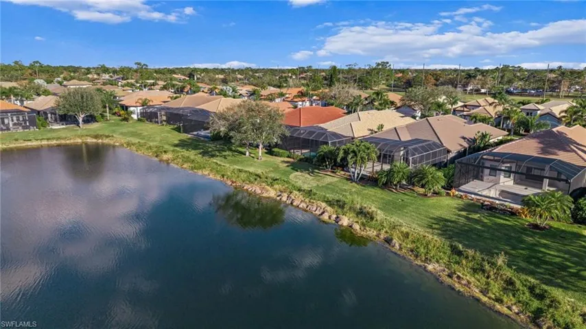 Aerial view of residential area featuring a large body of water