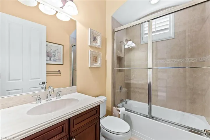 Full bathroom with vanity and combined bath / shower with glass door