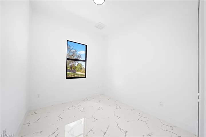 Unfurnished room with baseboards