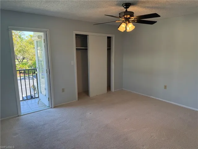 Main bedroom with attached bathroom and tiled patio