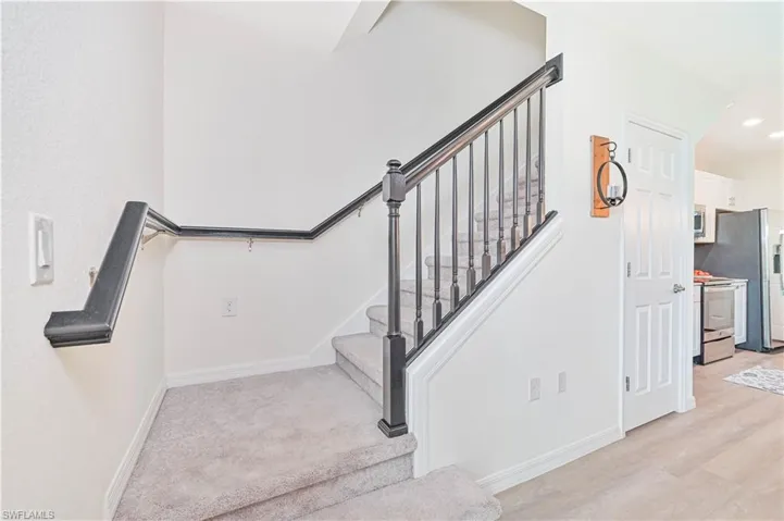 Staircase featuring wood-type flooring