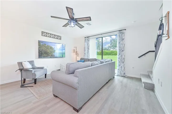 Living room featuring light wood-type flooring and ceiling fan