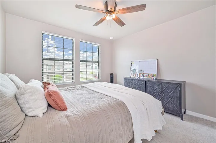 Carpeted bedroom with ceiling fan
