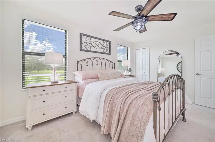 Bedroom featuring ceiling fan, light colored carpet, and a closet