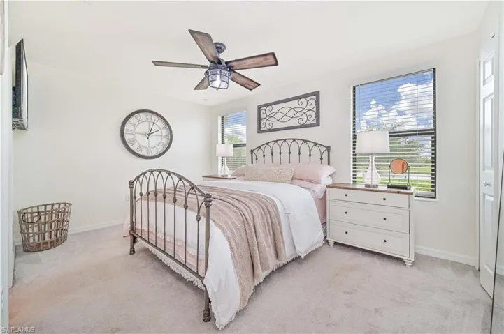 Bedroom with light colored carpet and ceiling fan