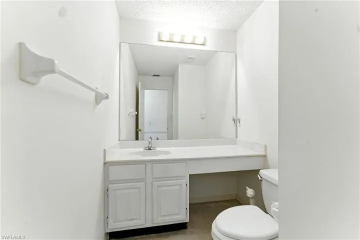 Bathroom featuring vanity and a textured ceiling