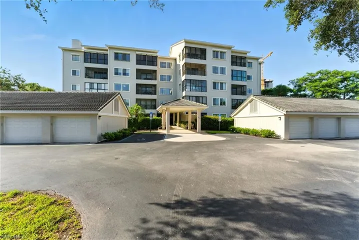 View of apartment building / complex with community garages