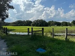 View of gate with a rural view