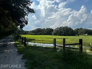 View of gate featuring a water view and a rural view