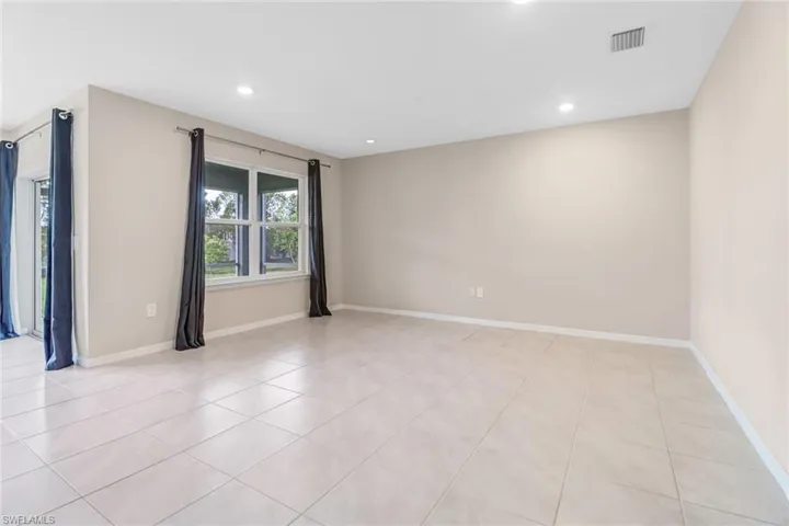 Empty room with light tile flooring