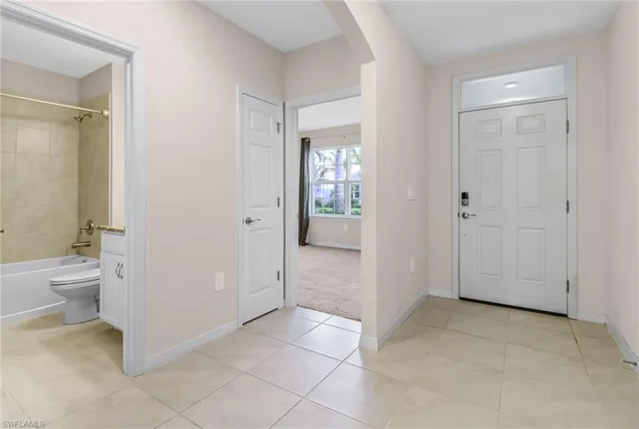 Foyer featuring light carpet