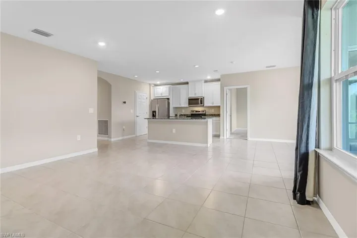 Unfurnished living room featuring light tile floors