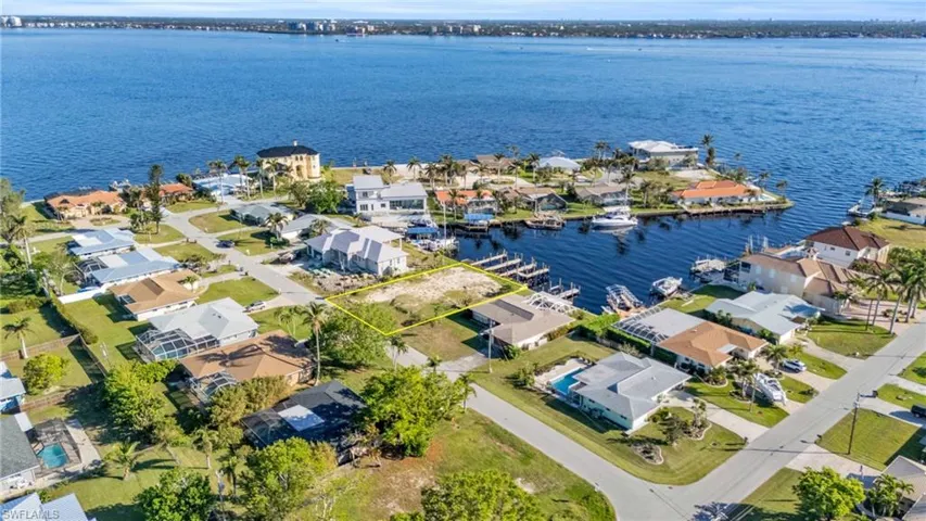 Birds eye view of property with a water view