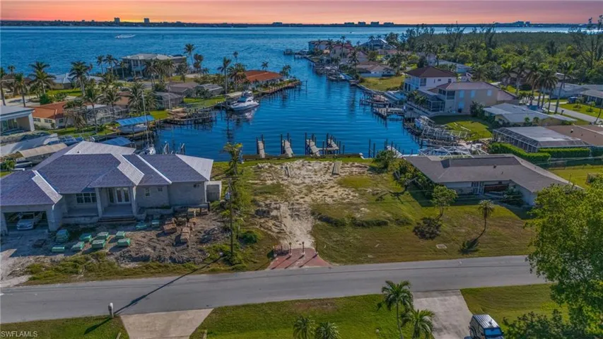 Aerial view at dusk featuring a water view