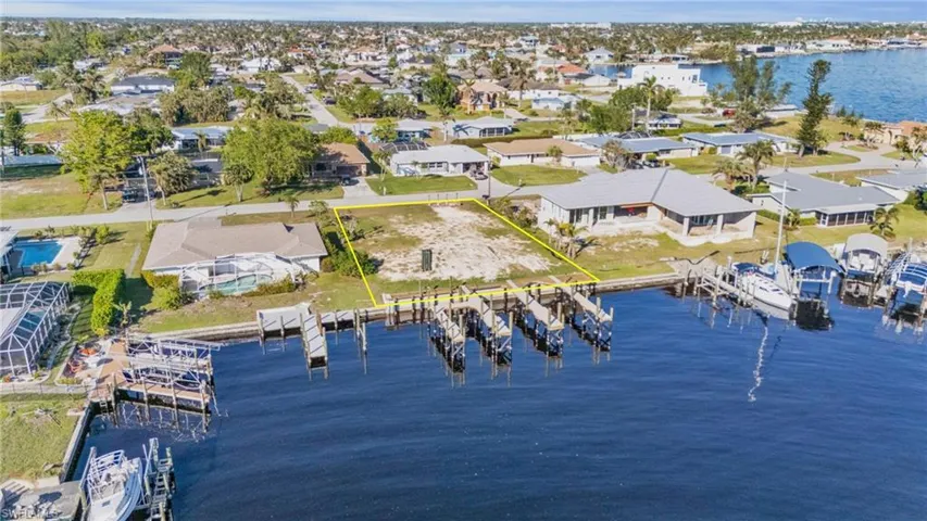 Birds eye view of property with a water view