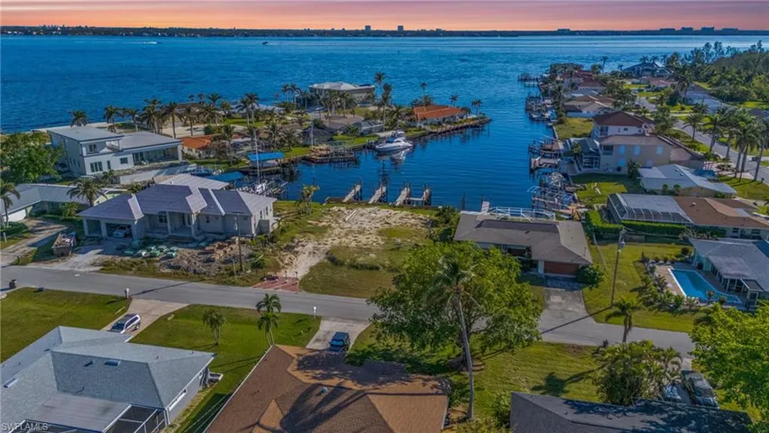 Aerial view at dusk featuring a water view