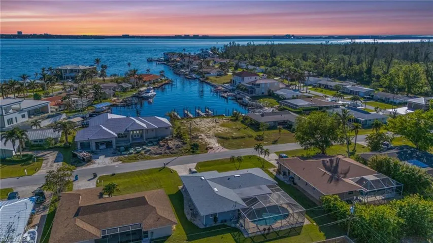 Aerial view at dusk featuring a water view