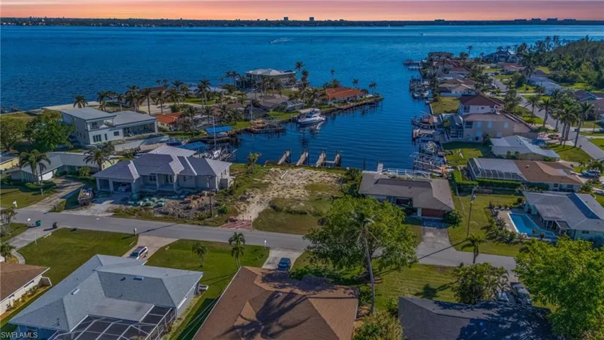 Aerial view at dusk featuring a water view