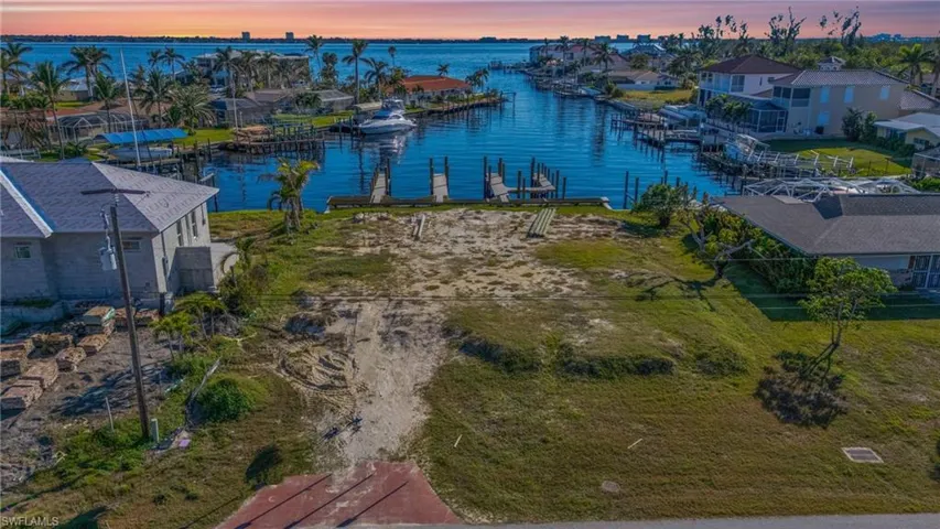 Aerial view at dusk featuring a water view