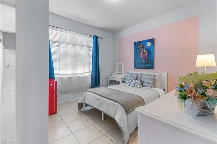 Room with tile flooring, a window with horizontal blinds, and a built-in closet with a white door