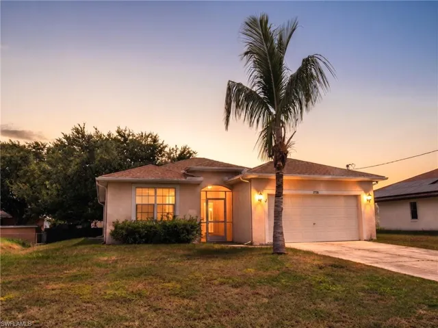 Stucco exterior with a single garage door and a concrete driveway