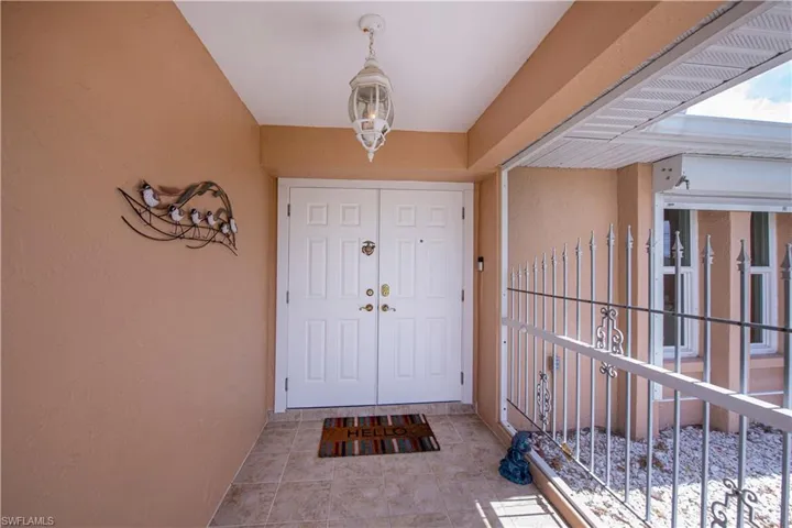 View of exterior double doors with screened entry area